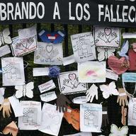 Tributes to lost love ones adorn a fence outside Brooklyn's Green-Wood Cemetery where many victims of COVID-19 are buried, Thursday, May 28, 2020 in New York. 