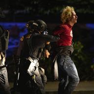 Portland police make arrests on the scene of the nightly protests at a Portland police precinct on Sunday, Aug. 30, 2020 in Portland, Ore.