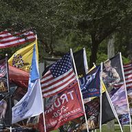 Flags and banners line the street outside of the campaign rally where President Donald Trump will speak at a rally, Thursday, Sept. 24, 2020, in Jacksonville, Fla.