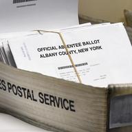 In this June 30, 2020, file photo, a box of absentee ballots wait to be counted at the Albany County Board of Elections in Albany, N.Y. Mail-in voting has gotten off to a rocky start in New York City.