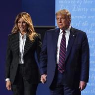 In this Sept. 29, 2020, file photo, President Donald Trump and first lady Melania Trump hold hands on stage after the first presidential debate at Case Western University and Cleveland Clinic.