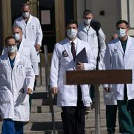 Dr. Sean Conley, physician to President Donald Trump, center, and other doctors, walk to talk with reporters at Walter Reed National Military Medical Center, Monday, Oct. 5, 2020, in Bethesda, Md.