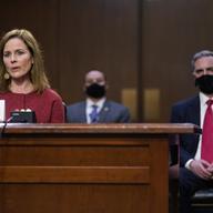 Supreme Court nominee Amy Coney Barrett speaks during a confirmation hearing before the Senate Judiciary Committee, Tuesday, Oct. 13, 2020, on Capitol Hill in Washington. Her family looks on at left.