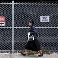 A woman walks past a COVID-19 testing site in the mostly Hasidic Jewish neighborhood of Borough Park. 
