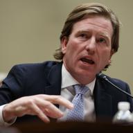 Christopher Krebs speaks at a microphone.