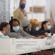 Polling workers inspect and count absentee ballots, Tuesday, Nov. 10, 2020, in New York. Counties across New York began to count more than 1.5 million absentee ballots Monday.