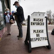Shoppers comply with the mask regulations to help prevent the spread of the coronavirus at Bridgton Books, Friday, Nov. 13, 2020, in Bridgton, Maine. 