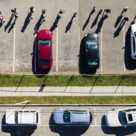 People line up in a parking lot filled with cars in West Hempstead, New York