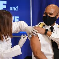 U.S. Surgeon General Jerome Adams receives a Pfizer-BioNTech COVID-19 vaccine shot at the Eisenhower Executive Office Building on the White House complex, Friday, Dec. 18, 2020, in Washington.