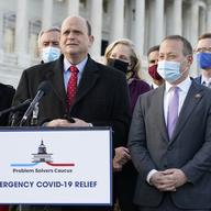 Problem Solvers Caucus co-chairs Rep. Tom Reed, R-N.Y., at podium, and Rep. Josh Gottheimer, D-N.J., right, speak to the media with members of their caucus about the expected passage of the emergency 