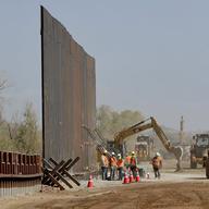 Contractors erect a section of border wall, replacing smaller fortifications, Tuesday, Sept. 10, 2019, along the Colorado River in Yuma, Ariz.