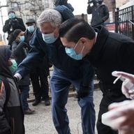 Mayor Bill de Blasio (left) and Schools Chancellor Richard Carranza (right) speak to a young public school student at P.S. 5 in the Bronx as he heads back to class after public schools closed for two