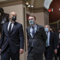 After violent protesters loyal to President Donald Trump stormed the U.S. Capitol, Sen. Cory Booker, D-N.J., left, and Sen. Michael Bennet, D-Colo., join other senators January 6, 2021.