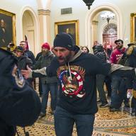 Trump supporters gesture to U.S. Capitol Police in the hallway outside of the Senate chamber at the Capitol in Washington, Wednesday, Jan. 6, 2021.