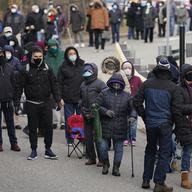 In this Jan. 21, 2021, file photo, people wait in line for the COVID-19 vaccine in Paterson, N.J.