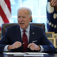 President Joe Biden signs a series of executive orders on health care, in the Oval Office of the White House, Thursday, Jan. 28, 2021, in Washington.