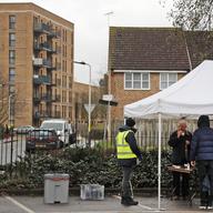 People take their own COVID-19 test at a newly set-up testing facility in a car park in West Ealing, London, Tuesday, Feb. 2, 2021, after it emerged that the South African strain of the coronavirus ma