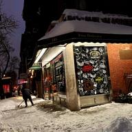 A corner store in a snow storm. 