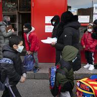 In this Dec. 7, 2020, file photo, students enter P.S. 134 Henrietta Szold Elementary School in New York.