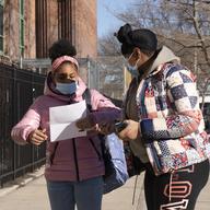 A student checks her paperwork with her mother before entering Meyer Levin Middle School, Thursday, Feb. 25, 2021, in New York. 