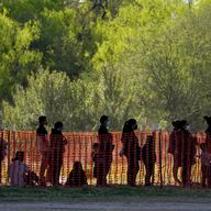 In this Friday, March 19, 2021, photo migrants are seen in custody at a U.S. Customs and Border Protection processing area under the Anzalduas International Bridge in Mission, Texas.