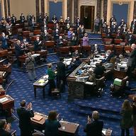 In this image from video, senators stand and applaud support staff, before the final vote on the Senate version of the COVID-19 relief bill in the Senate at the U.S. Capitol in Washington, Saturday.