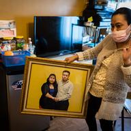 Zenaida Morales holds a portrait of herself and her husband