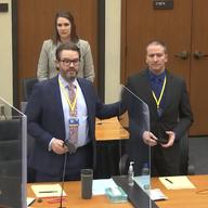 In this screen grab from video, defense attorney Eric Nelson, left, defendant and former Minneapolis police officer Derek Chauvin, right, and Nelson's assistant Amy Voss, back.