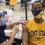 Kent State University student Marz Anderson gets his Johnson & Johnson COVID-19 vaccination from Kent State nurse Beth Krul in Kent, Ohio, Thursday, April 8, 2021.
