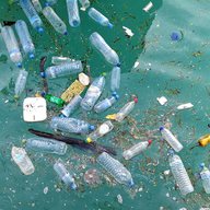 plastic water bottles and other debris floating in the ocean