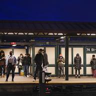 In this April 22, 2021 file photo, patrons wait for the #7 train at the 74th street subway station in the Queens borough of New York.