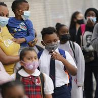 In this Sept. 9, 2020, file photo, students wear protective masks as they arrive for classes at the Immaculate Conception School while observing COVID-19 prevention protocols in The Bronx.