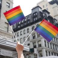 An attendee holds up flags during the New York City Pride Parade, Sunday, June 24, 2018, in New York.