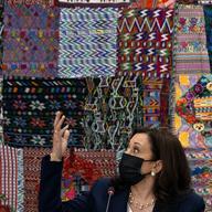 Vice President Kamala Harris gestures in front of traditional textiles as she attends a meeting with Guatemalan women entrepreneurs at the Universidad del Valle de Guatemala, in Guatemala City, Monday