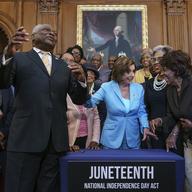 House Majority Whip James Clyburn, D-S.C., left, celebrates with Speaker of the House Nancy Pelosi and members of the Congressional Black Caucus after passage of the Juneteenth National Independence
