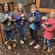 Members of the Abta family, from left, Allison, Violet, Eli, and Ariella hold hens in front of their backyard chicken run in Ross, Calif., on Dec. 15, 2020.