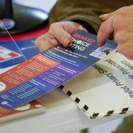 In this Monday, June 14, 2021, file photo, an election worker goes over a ranked choice voting explanation card with a voter.