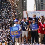 New York City Mayor Bill de Blasio waves from a float during a parade honoring essential workers for their efforts in getting New York City through the pandemic on July 7, 2021.