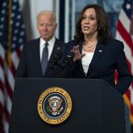 President Joe Biden listens as Vice President Kamala Harris speaks during an event to mark the start of monthly Child Tax Credit relief payments, in the South Court Auditorium on the White House compl