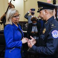Rep. Liz Cheney, R-Wyo., speaks with U.S. Capitol Police Sgt. Aquilino Gonell after a House select committee hearing on the Jan. 6 attack on Capitol Hill in Washington, Tuesday, July 27, 2021. 