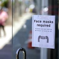 A sign advises shoppers to wear masks outside of a store Monday, July 19, 2021, in the Fairfax district of Los Angeles.