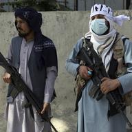 Taliban fighters stand guard in the main gate leading to Afghan presidential palace, in Kabul, Afghanistan, Monday, Aug. 16, 2021. The U.S. military struggled to manage a chaotic evacuation.