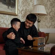 Father and son listening to radio