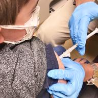 A 6-year-old gets his COVID shot in the Bronx.
