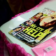 An old OK! magazine with Britney on the cover and text that reads 'My cry for help!' is seen on a table at a #FreeBritney Rally.