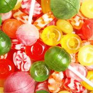 Different delicious colorful candies as background, top view