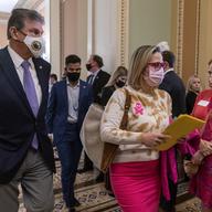 Sen. Joe Manchin, D-W.Va., left, walks with Sen. Kyrsten Sinema, D-Ariz., after attending a Democratic policy luncheon, Tuesday, Nov. 16, 2021, on Capitol Hill in Washington.