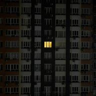 An illuminated window on a residential building with the rest of the lighting turned off for safety reasons, in the city of Kyiv, Ukraine.
