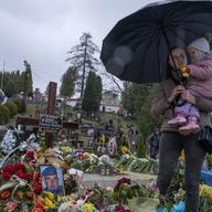 25-year-old widow Oleksandra Rurak visits her soldier husband Volodymyr Rurak's grave with her one and a half year old daughter, after he was killed in action, in Lviv, western Ukraine, on April 5, 22