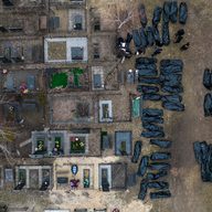 Aerial view of body bags lying in a cemetery. 